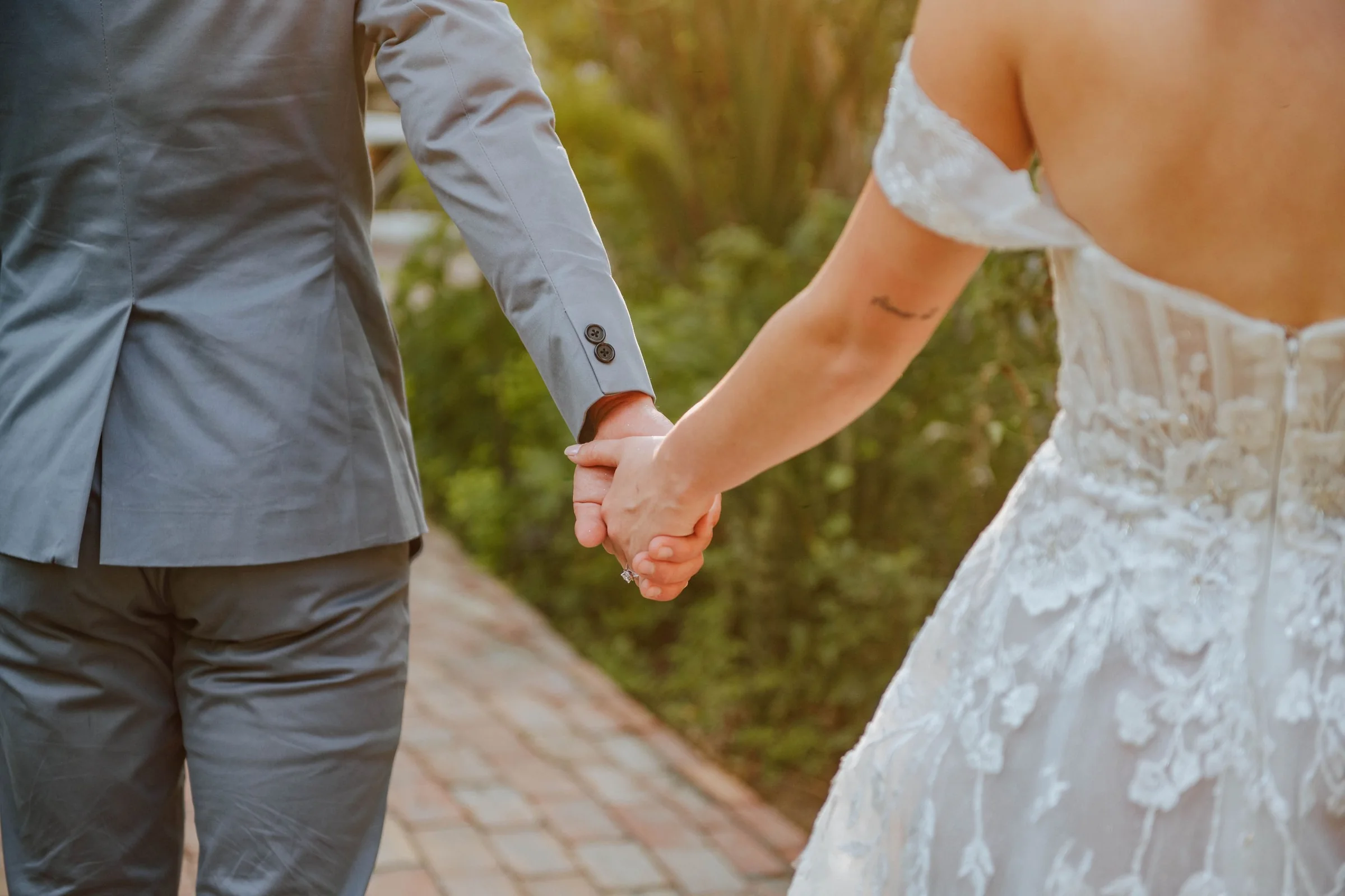 Sidney and Omar holding hands after the ceremony